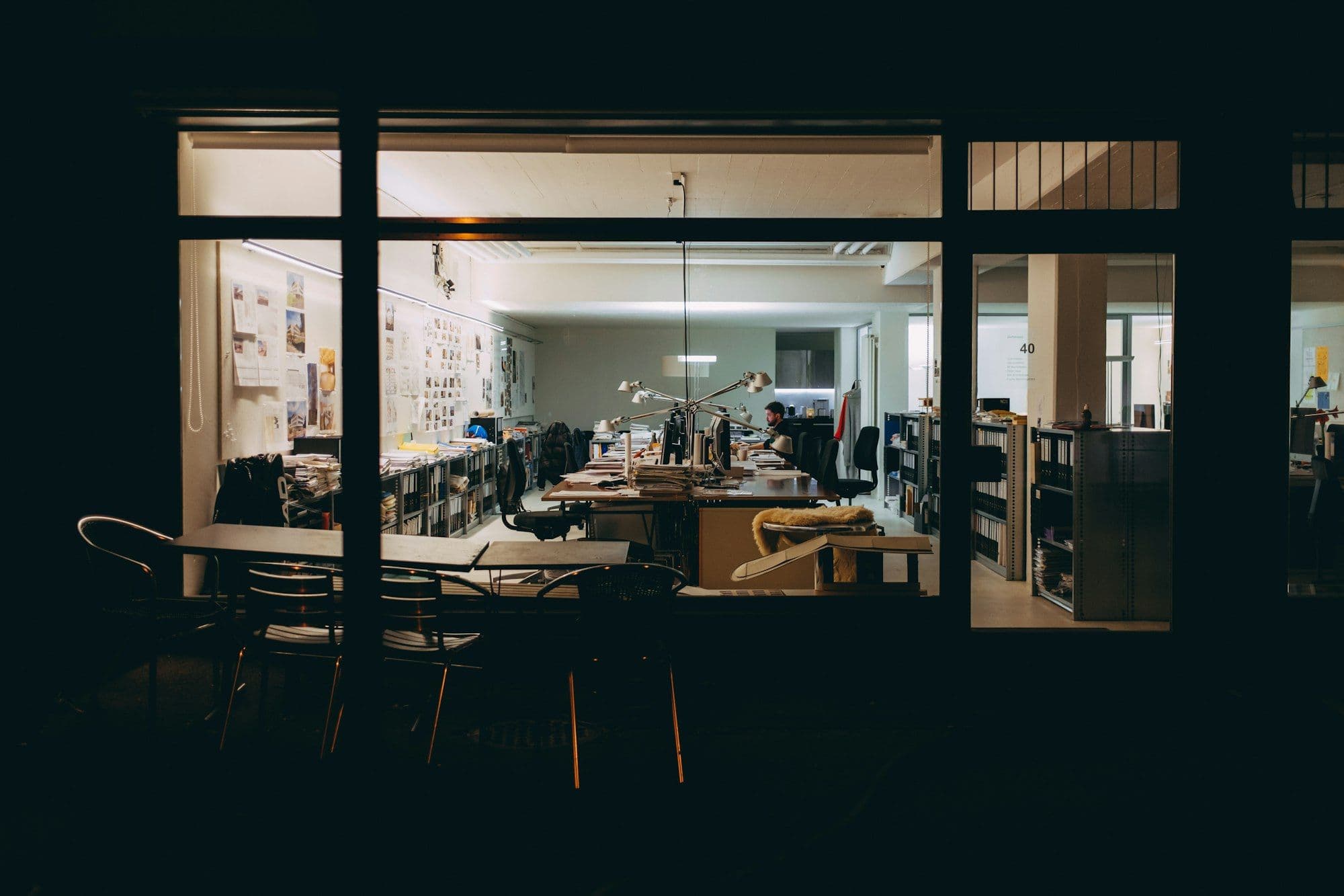 A small business office lit up and busy with work at night
